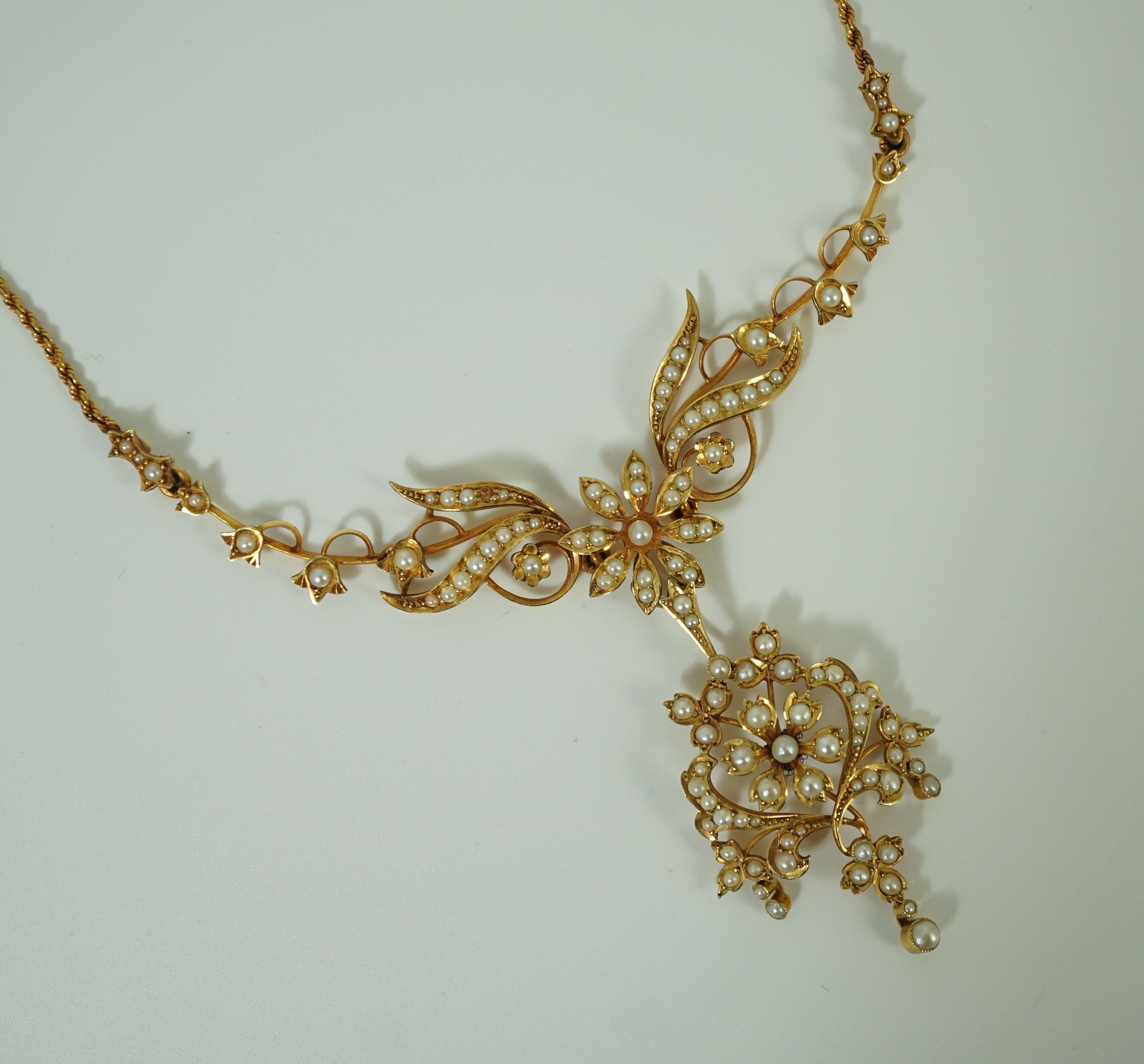 A late Victorian 15ct gold and seed pearl set drop pendant necklace
